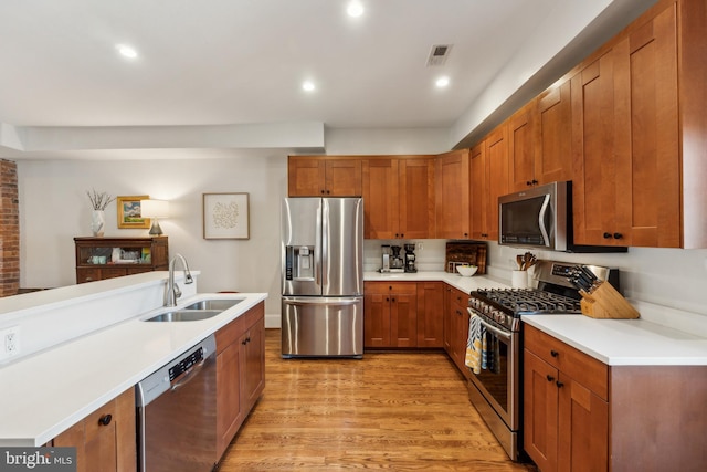 kitchen featuring visible vents, a sink, appliances with stainless steel finishes, and light countertops