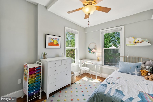 bedroom featuring baseboards, ceiling fan, and wood finished floors