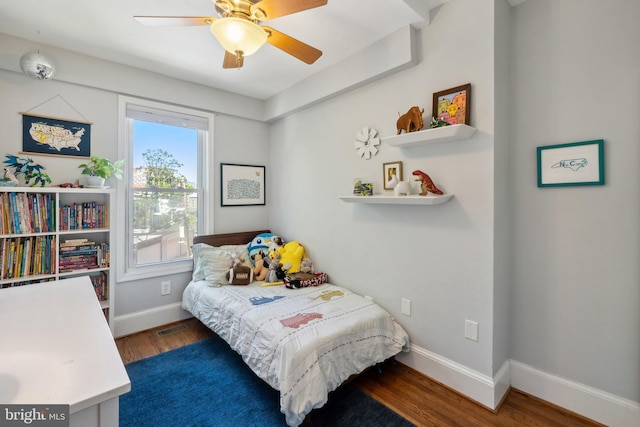bedroom featuring baseboards, ceiling fan, wood finished floors, and visible vents