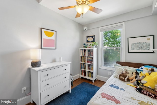 bedroom featuring baseboards, dark wood-style flooring, and ceiling fan