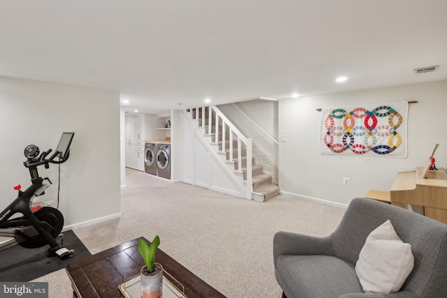 interior space featuring stairway, baseboards, visible vents, and washer and clothes dryer