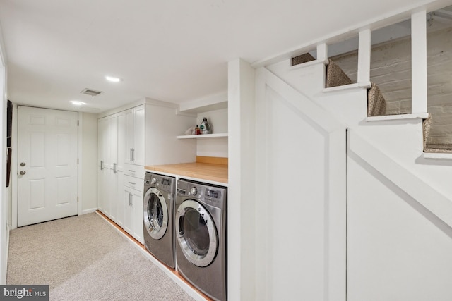 laundry room featuring separate washer and dryer, visible vents, light carpet, and recessed lighting