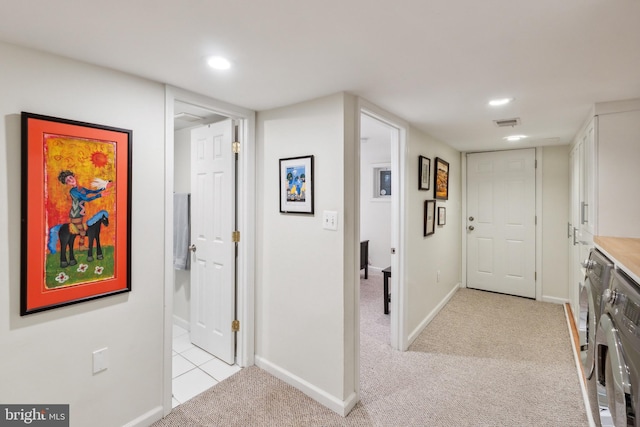 hallway featuring light colored carpet, recessed lighting, baseboards, and independent washer and dryer