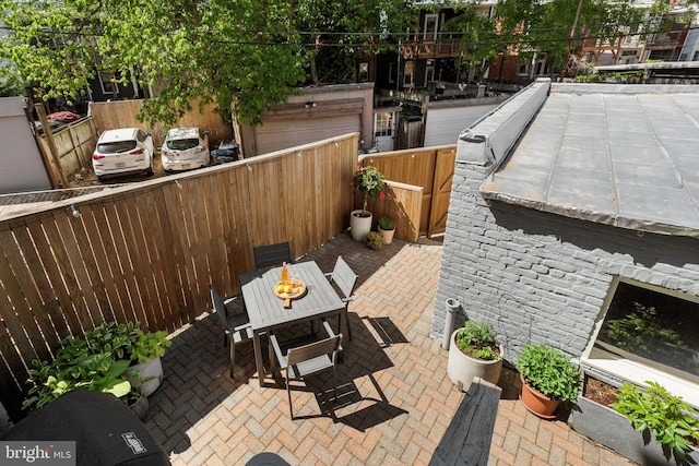 view of patio with fence and outdoor dining area