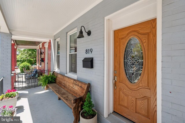 property entrance with covered porch