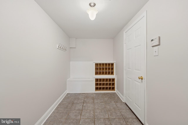 walk in closet with tile patterned floors