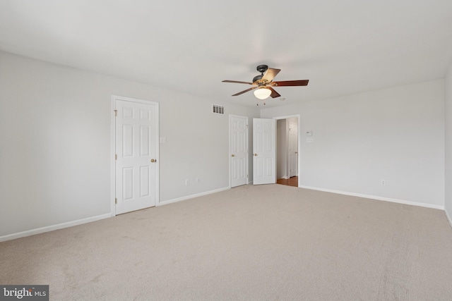 unfurnished bedroom featuring carpet, visible vents, baseboards, and ceiling fan