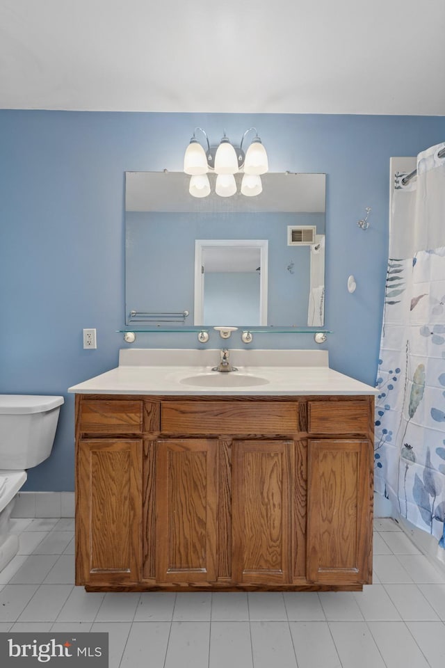 bathroom with toilet, a shower with curtain, tile patterned floors, visible vents, and vanity