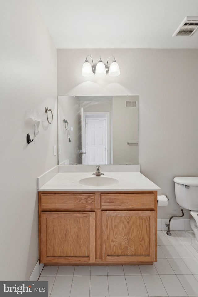 bathroom featuring vanity, toilet, visible vents, and tile patterned flooring