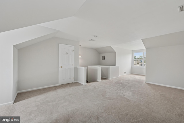 bonus room with vaulted ceiling, carpet flooring, baseboards, and visible vents
