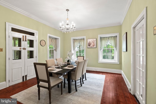 dining space featuring crown molding, a chandelier, french doors, dark wood finished floors, and baseboards
