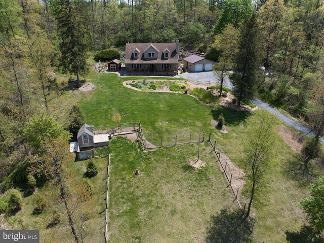 birds eye view of property with a wooded view