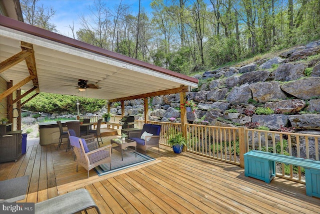 deck featuring ceiling fan and an outdoor living space