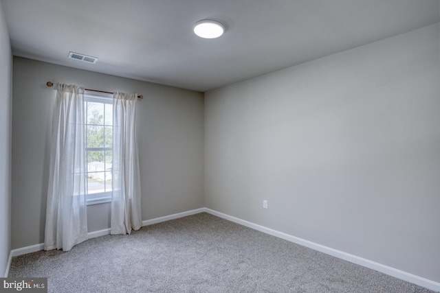 empty room with visible vents, baseboards, and carpet floors