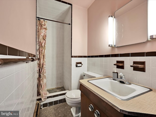 full bath featuring toilet, tile walls, a sink, and a stall shower