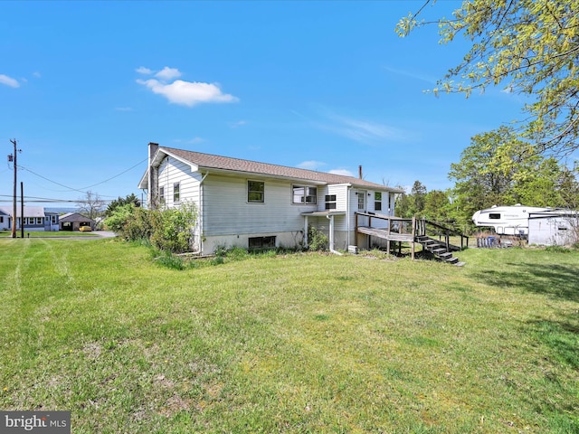 back of house featuring a yard and a deck