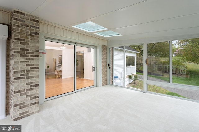 unfurnished sunroom with a skylight
