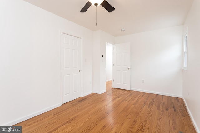 unfurnished bedroom featuring a ceiling fan, light wood finished floors, and baseboards