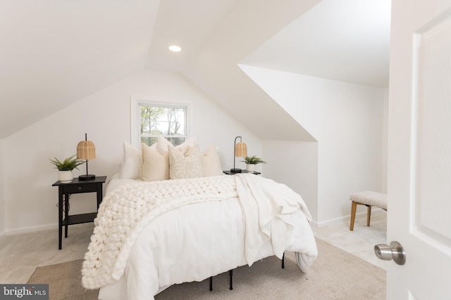 bedroom with lofted ceiling, light colored carpet, and baseboards