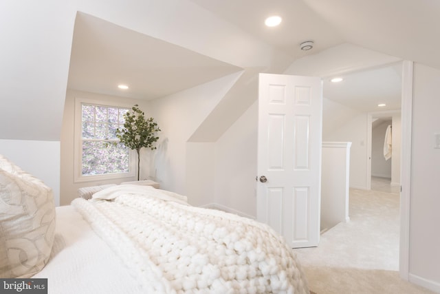 bedroom featuring lofted ceiling, light colored carpet, and recessed lighting