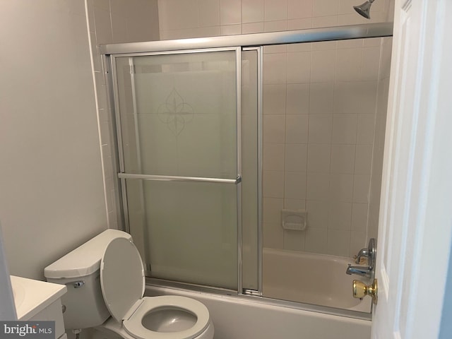 full bath featuring vanity, combined bath / shower with glass door, and toilet