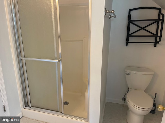 full bath with toilet, baseboards, a shower stall, and tile patterned floors
