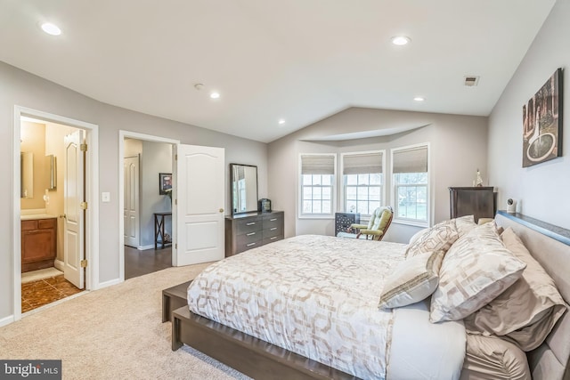 carpeted bedroom featuring recessed lighting, ensuite bath, vaulted ceiling, baseboards, and visible vents