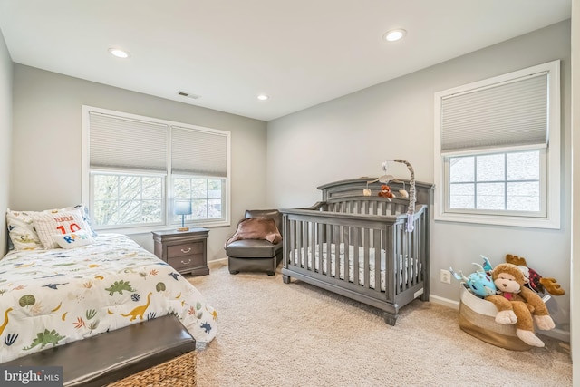 carpeted bedroom featuring recessed lighting, visible vents, and baseboards