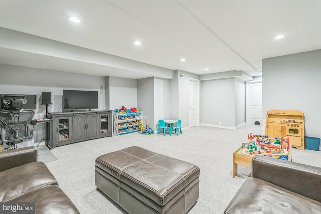 carpeted living area featuring recessed lighting and baseboards