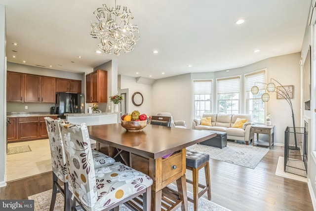 dining space featuring recessed lighting, a chandelier, and wood finished floors