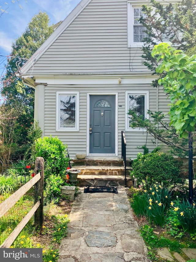 view of exterior entry with fence