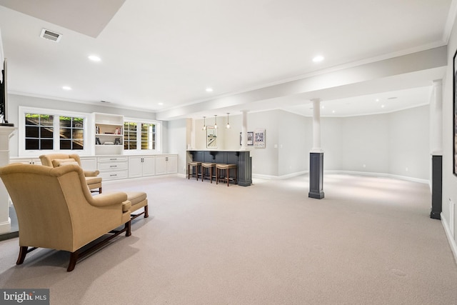 living area with visible vents, ornamental molding, light colored carpet, and a dry bar