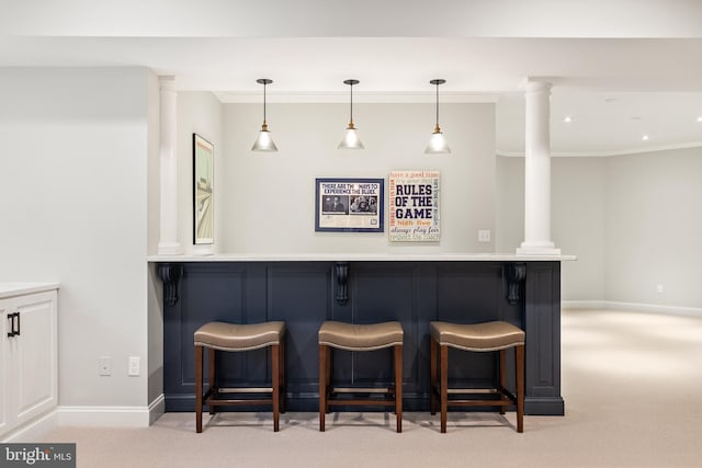 bar with a dry bar, light colored carpet, crown molding, and hanging light fixtures