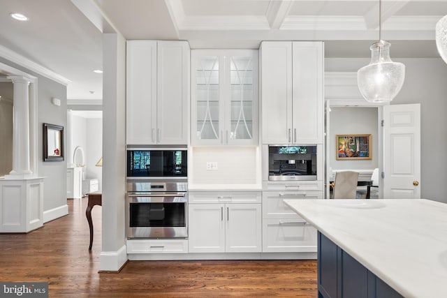 kitchen featuring white cabinets, built in microwave, oven, recessed lighting, and ornate columns