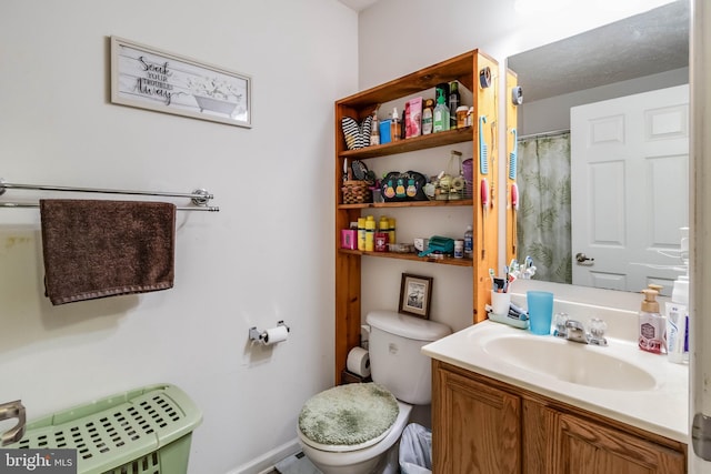 5135 Clark Canning House Rd, Federalsburg, MD 21632 - full bath with toilet, vanity, a shower with shower curtain, and baseboards