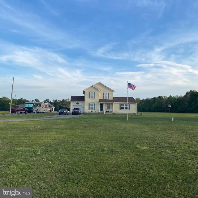 view of front of house with a front yard and a garage