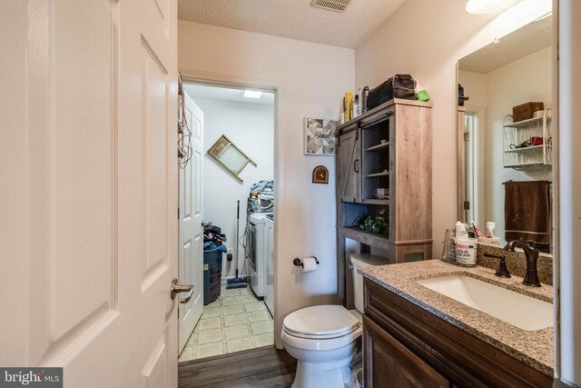 5135 Clark Canning House Rd, Federalsburg, MD 21632 - bathroom featuring washing machine and clothes dryer, wood finished floors, vanity, and toilet