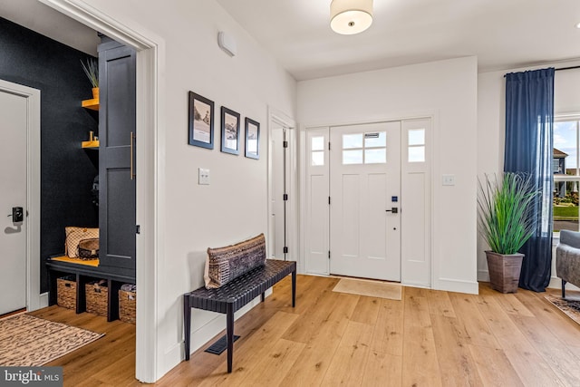 foyer entrance with visible vents and light wood finished floors