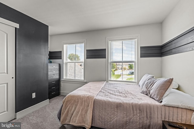 bedroom featuring carpet floors and baseboards