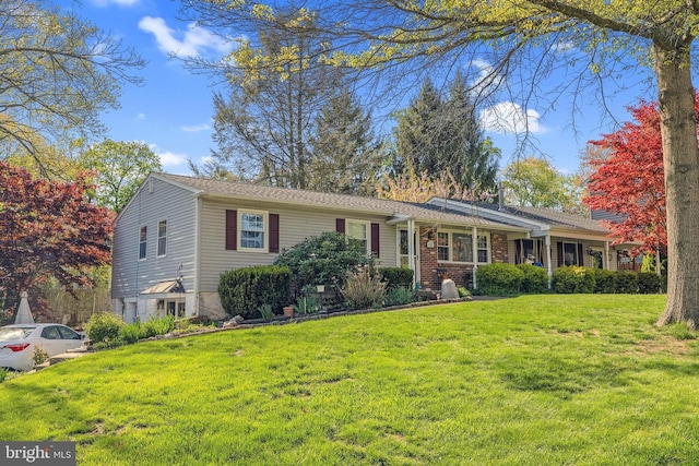 ranch-style home with a front lawn