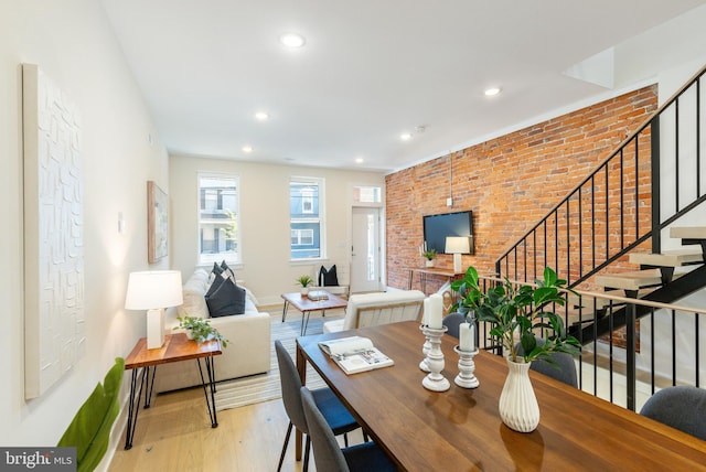 2131 Wharton St, Philadelphia, PA 19146 - dining space featuring wood finished floors, brick wall, baseboards, stairway, and recessed lighting