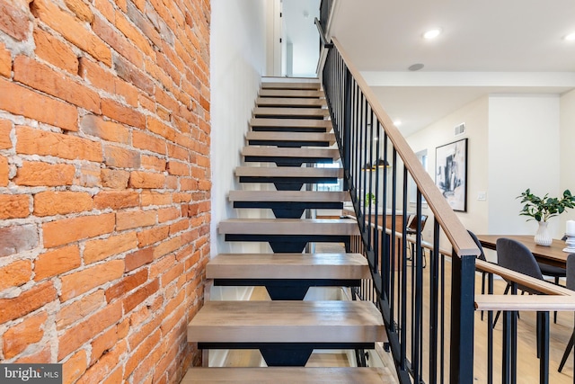 2131 Wharton St, Philadelphia, PA 19146 - stairway with recessed lighting, brick wall, and visible vents