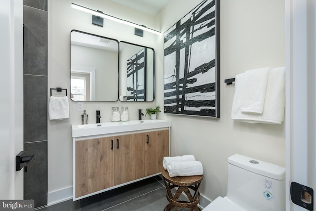 2131 Wharton St, Philadelphia, PA 19146 - bathroom featuring double vanity, baseboards, toilet, and a sink