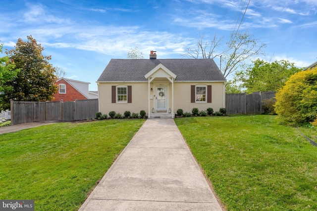 6825 Kincaid Ave, Falls Church, VA 22042 - view of front facade with a chimney, roof with shingles, fence, and a front yard