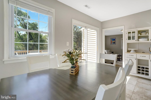6825 Kincaid Ave, Falls Church, VA 22042 - dining space with light tile patterned flooring, visible vents, and plenty of natural light