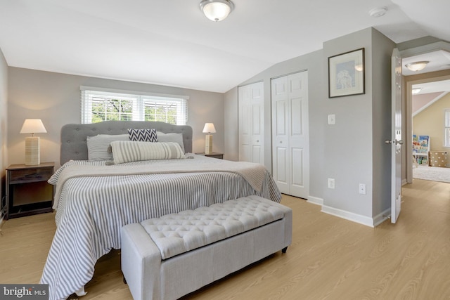 6825 Kincaid Ave, Falls Church, VA 22042 - bedroom featuring light wood-type flooring, baseboards, two closets, and vaulted ceiling