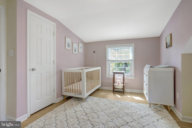 6825 Kincaid Ave, Falls Church, VA 22042 - bedroom with light wood-style floors, a crib, baseboards, and lofted ceiling