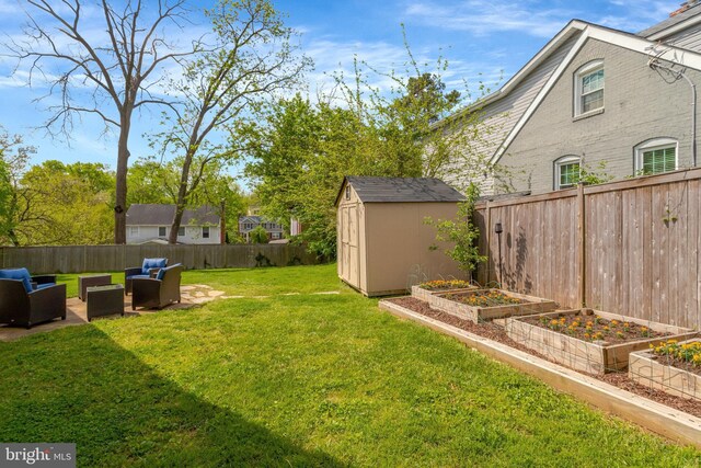 6825 Kincaid Ave, Falls Church, VA 22042 - view of yard with a fenced backyard, a vegetable garden, an outdoor living space, a storage unit, and an outbuilding