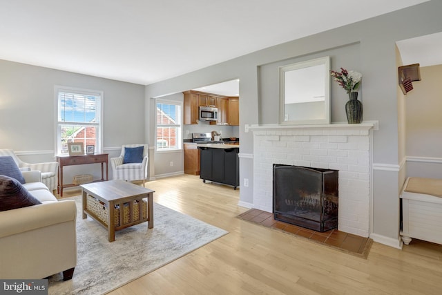 6825 Kincaid Ave, Falls Church, VA 22042 - living area with baseboards, a fireplace, and light wood-style flooring