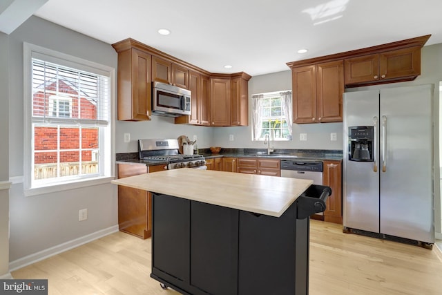 6825 Kincaid Ave, Falls Church, VA 22042 - kitchen featuring a sink, light wood finished floors, brown cabinetry, stainless steel appliances, and recessed lighting